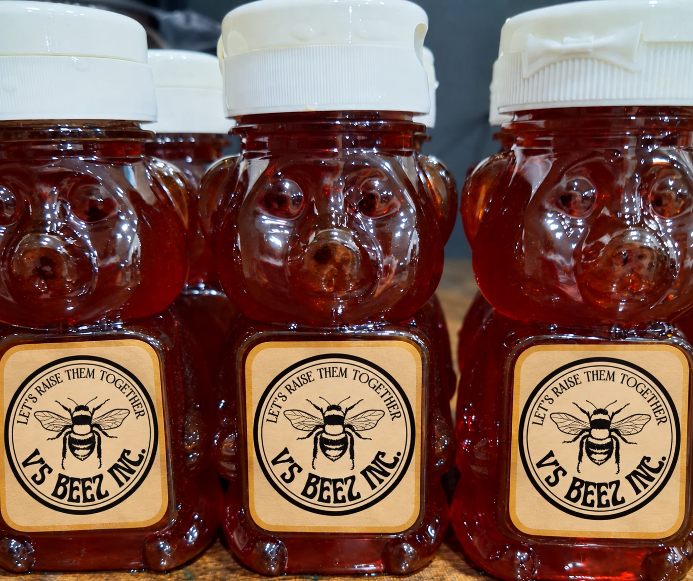 V's Beez honey in bear-shaped bottles with the Let's Raise Them Together label